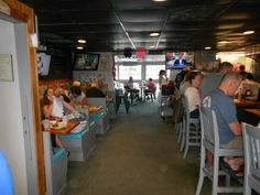 people are sitting at tables in a restaurant