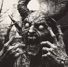 an evil looking demon with large horns and huge eyes is shown in black and white