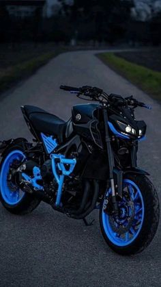 a black and blue motorcycle parked on the street