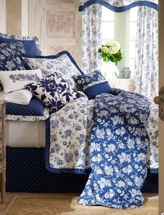 a bedroom with blue and white bedding in it