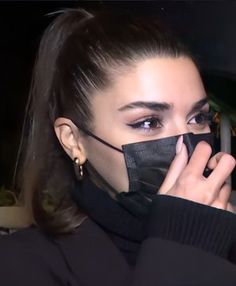 a woman wearing a black face mask covering her mouth