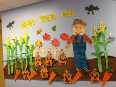 a bulletin board with scarecrows and pumpkins