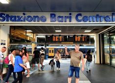 people are walking in front of the entrance to stazione bar central train station