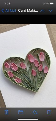 a heart shaped card with pink flowers on it