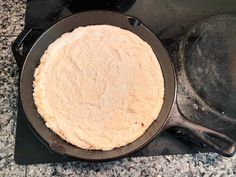 a pan with some food cooking in it on top of a stovetop next to a frying pan