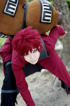 a man with red hair is holding two large stuffed animals on his back