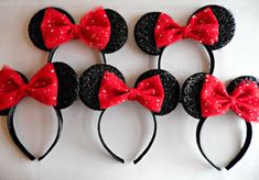 four mickey mouse ears with red bows and polka dots on them, all lined up in a row