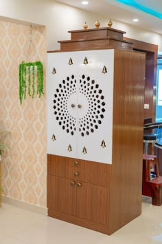 a cabinet in the middle of a room with an intricate design on it's door