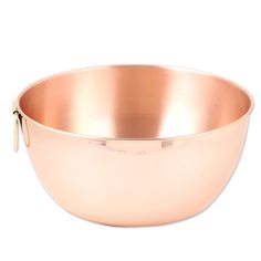 a large metal bowl with a gold handle on a white background and clippings to the side