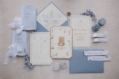 the wedding stationery is laid out on the floor