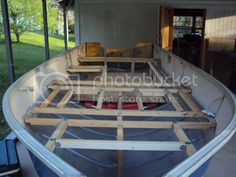 a boat is being built in the back of a house with wooden rafts on it