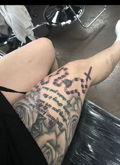 a woman's legs with tattoos on them and words written in black ink above her ankles