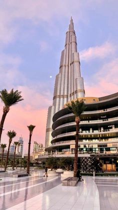 the burj building is surrounded by palm trees