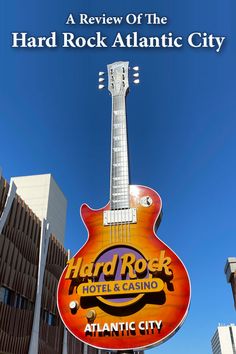 the sign for hard rock atlantic city with a guitar hanging from it's side