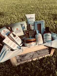 a wooden crate filled with personal care products on top of a grass covered field,