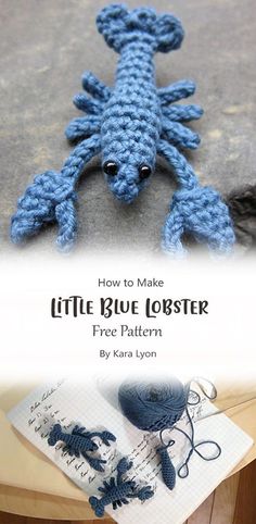 a crocheted blue lobster sitting on top of a table next to an open book