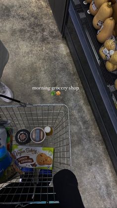 a shopping cart in a grocery store filled with groceries and food items that are on display