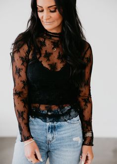 The Kalin Lace Mesh Top combines elegant lace and airy mesh for a sophisticated look. Complete with long sleeves and a mock neckline. Laurie is wearing a size small. Measurements: Body Length: 25.5" | Sleeve Length: 25" Small: Bust: 32" Arm: 10" Medium: Bust: 33" Arm: 11" Large: Bust: 34" Arm: 12" 90% Nylon 10% Spandex Trendy Vegas Outfits, Mesh Top Leather Pants, Western Mesh Top Outfit, How To Style A Mesh Top, Lace Shirt Outfits, How To Style Lace Top, Long Sleeve Lace Top Outfit, Lace Layering Top Outfit, Lace Top With Jeans