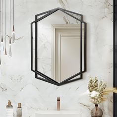 a bathroom with marble walls and flooring, a mirror on the wall above the sink