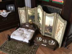 there is a bed with two bowls on it and an armoire in the middle