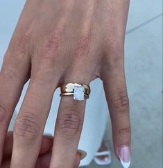 a woman's hand with two rings on it and one ring in the middle