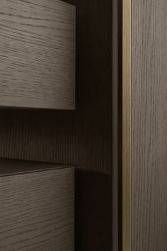 a close up view of some wood grains on a cabinet door with brass handles