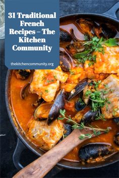 a pan filled with seafood and mussels next to a wooden spoon