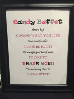 a candy buffet sign is displayed in a black frame with pink and red writing on it