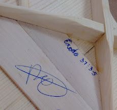 a close up of a kite with writing on it and a mirror in the background