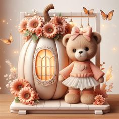 a teddy bear is standing next to a pumpkin with flowers on it and butterflies flying around