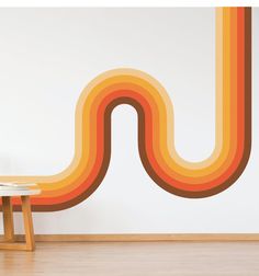 an orange and yellow striped wall with a table in the foreground, next to it