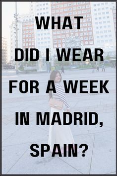 a woman standing in front of tall buildings with the words what did i wear for a week in madrid, spain?