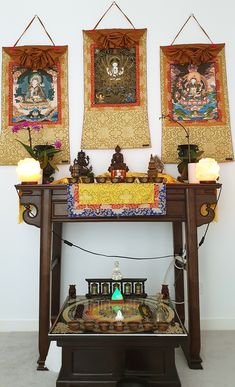 Buddhist altar with statues and thangka paintings Tibetan Buddhist Altar, Buddhist Monastery Interior, Buddhist Altar Design, Buddhist Altar Home Ideas, Buddha Altar Ideas, Buddhist Altar Home, Japanese Meditation Room, Spiritual Altar Ideas, Shrine Ideas