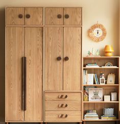 a large wooden cabinet sitting next to a bookshelf