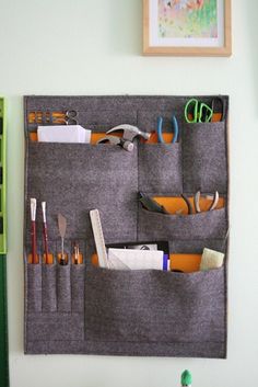 the wall hanging organizer is organized with scissors and other office supplies