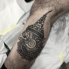 a black and white tattoo on the arm of a man