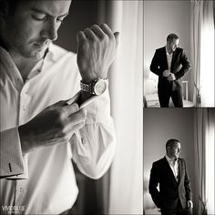 a black and white photo of a man adjusting his watch