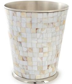 a white and gold mosaic waste basket on a chrome plated stand with a metal base