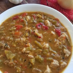 a white bowl filled with soup on top of a wooden table