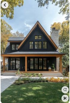 a black and brown house with lots of windows