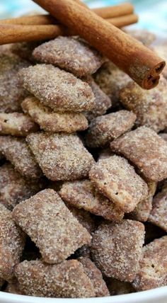 cinnamon sugar cookies in a white bowl with cinnamon sticks