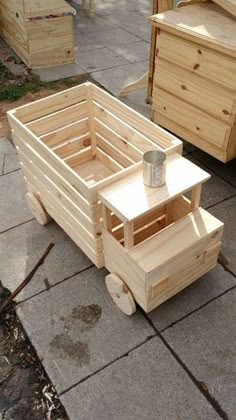 a wooden cart with drawers sitting on the ground