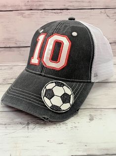 ATHLETE'S NUMBER CAP This cap can be embroidered with your athlete's jersey number! ITEM DETAILS:These caps can be embroidered with any 2 numbers & sports ball of your choice. The caps come in the distressed trucker or the "dad" cap style in a variety of colors. The numbers are a vinyl applique embroidered on the cap in either glitter or solid colors. The sports ball is also vinyl and glued to the cap using an industrial strength glue. The thread color chart should be used to select the color of Gray Sports Baseball Cap With Letter Print, Sporty Team-colored Trucker Hat For College, Gray Snapback Hat For Baseball Season Sports Events, Sporty Trucker Hat For College In Team Colors, Gray Trucker Hat For Baseball Season Sports Events, Team Spirit Snapback Hat For Baseball, Team-colored Baseball Cap For Sports Season Events, Team-colored Trucker Hat With Letter Print For Sports Events, Sporty Baseball Cap With Letter Patch