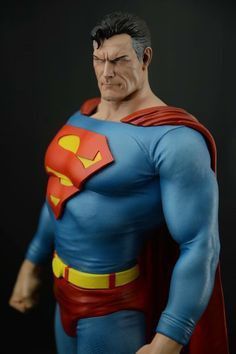 a close up of a superman action figure on a black background