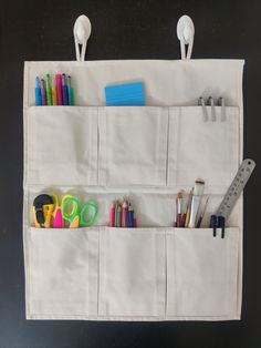 a white bag with scissors, pencils and pens in it