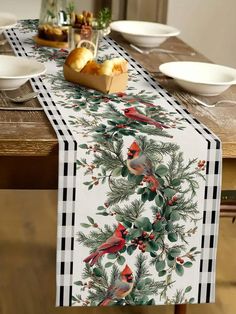 the table is set with plates, bowls and napkins on it for christmas dinner