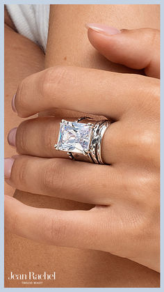 a woman's hand with a ring on it and a diamond in the middle