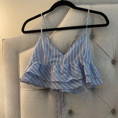 Super Cute White And Blue Patterned Tank. Tighter In Chest Area And Has Ruffles Under Near Stomach. Super Cute In Summer With White Jeans/ Shorts. Never Worn Fitted Ruffle Hem Crop Top For Summer, Chic Forever 21 Top With Ruffles, Chic Forever 21 Tops With Ruffles, Forever 21 Sleeveless Tops With Ruffles, Forever 21 Cotton Ruffle Top, Forever 21 Ruffled Top For Brunch, Blue Ruffle Hem Top For Beach, Forever 21 Blue Crop Top For Spring, Blue Cropped Ruffle Top