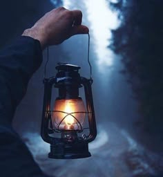 a person holding a lantern in their hand