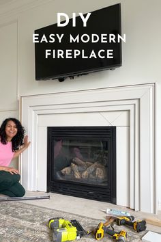 a woman sitting on the floor in front of a fire place with tools around her